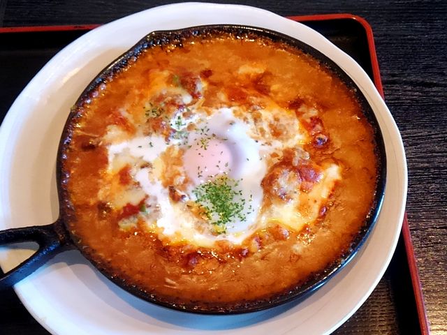 イタリアントマト焼きカレーにはトマトソースと半熟玉子が加わります。_カフェ うまめしゴォー(郷)
