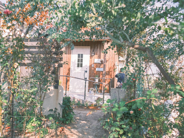 緑の樹木に囲まれた中庭にアトリエ小屋があります_バラとやまぼうし
