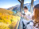 美しく紅葉する山のなかに、底知れぬエメラルドグリーンの湖が静かに佇んでいる