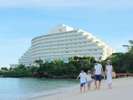 【万座ビーチ】エメラルドグリーンの透明度の高い海と白砂のビーチから眺める白亜のホテル棟