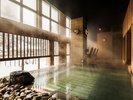 【大浴場 鹿の湯】当館に隣接する本館の大浴場。定山渓で唯一名の付く名湯の圧倒的湯力を堪能あれ
