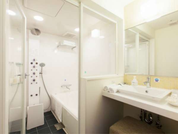 ツインルームのバスルームと洗面所、トイレはセパレートタイプ。多機能シャワーパネルをお楽しみください。