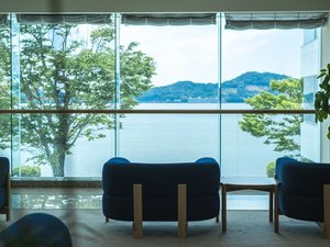 明るい陽射しが差し込むフロントロビー。窓の向こう側には煌めく湖。